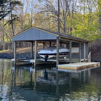 Double-slip dock with covered boat storage and composite decking.